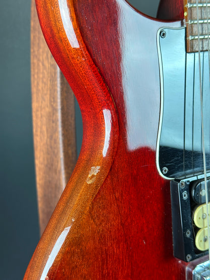 Close-up of a guitar's body with a visible scratch.