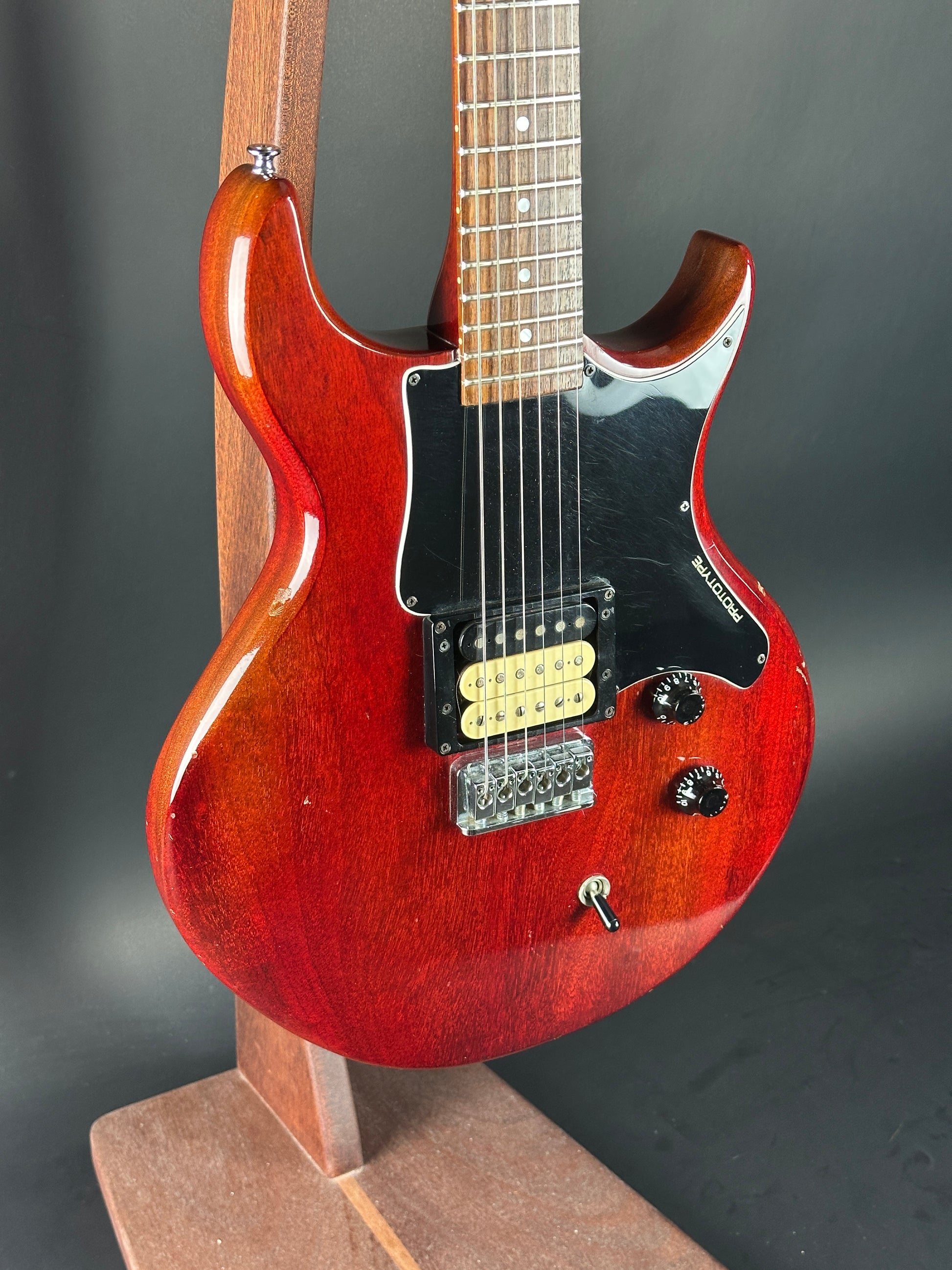 Red electric guitar on a dark background