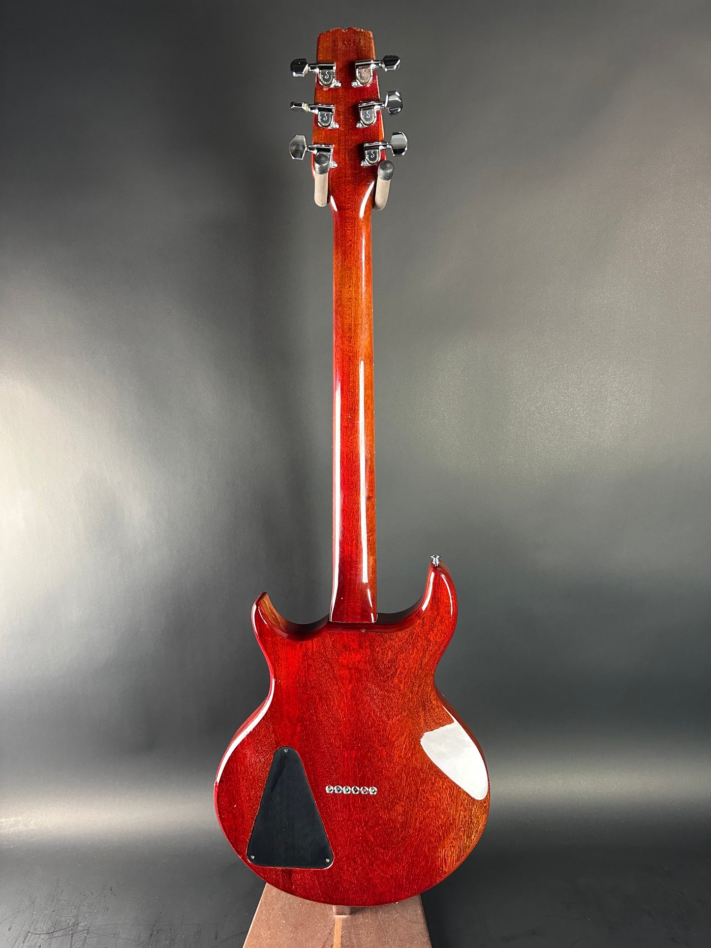 Red electric guitar on a gray background