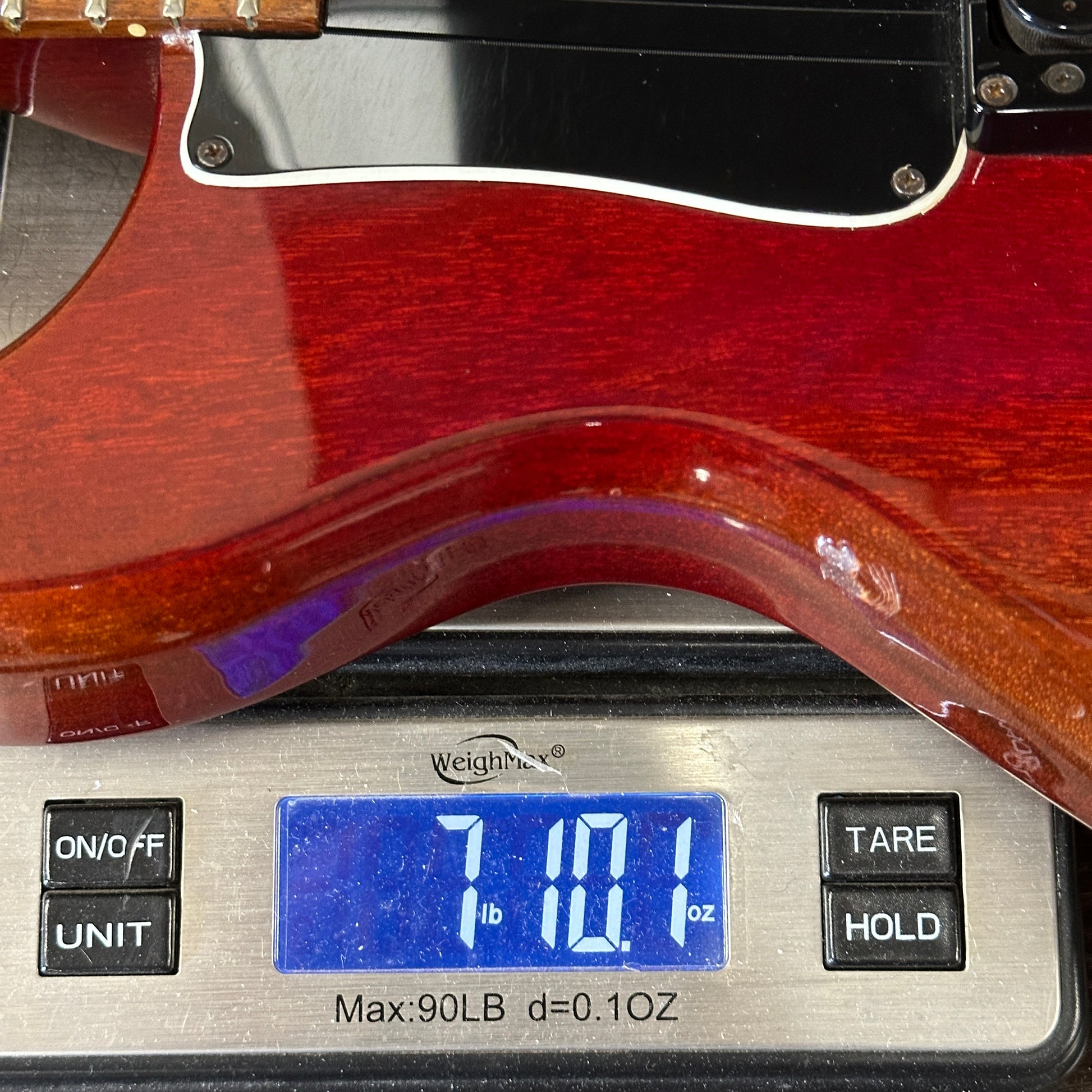 Guitar on a digital scale displaying weight