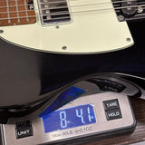 Used Schecter Diamond Series Nick Johnston DT Tele on scale displaying weight.