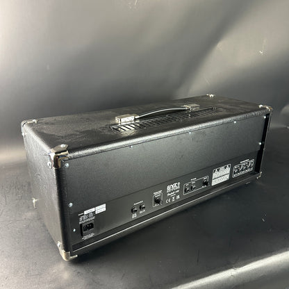 Back view of a guitar amplifier on a gray surface with a neutral background