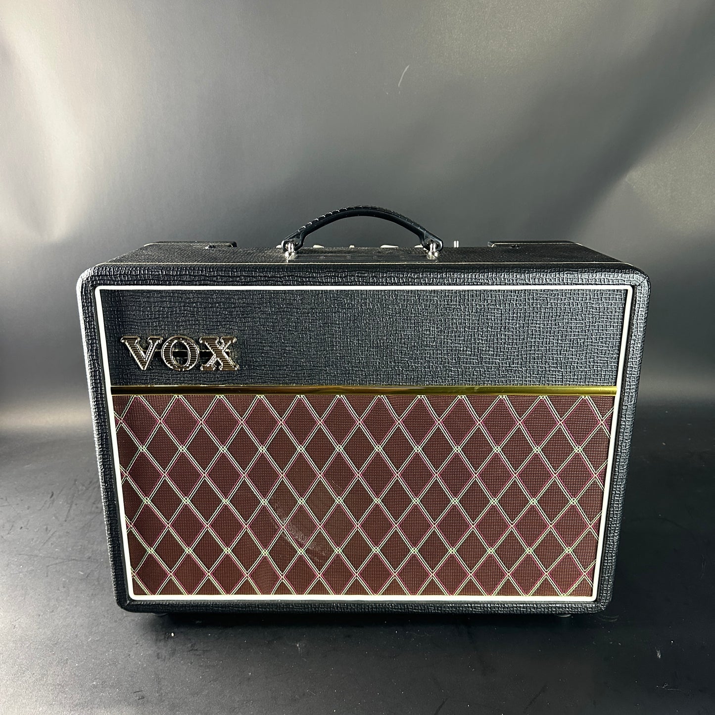 VOX amplifier with diamond pattern on a gray background