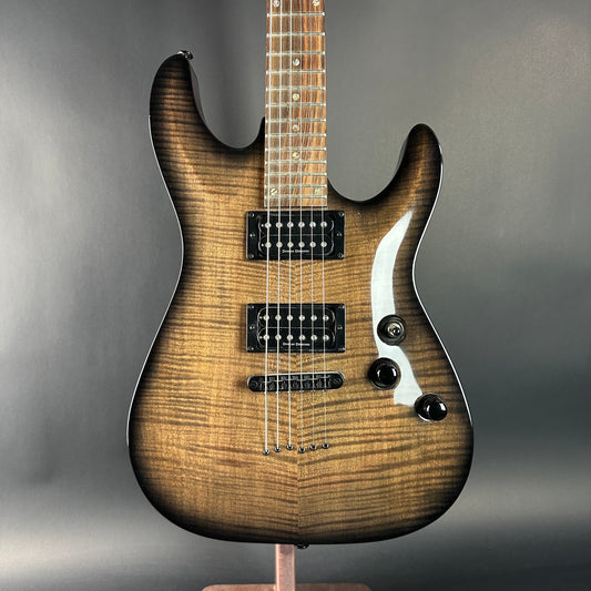Electric guitar with a wooden finish on a gray background
