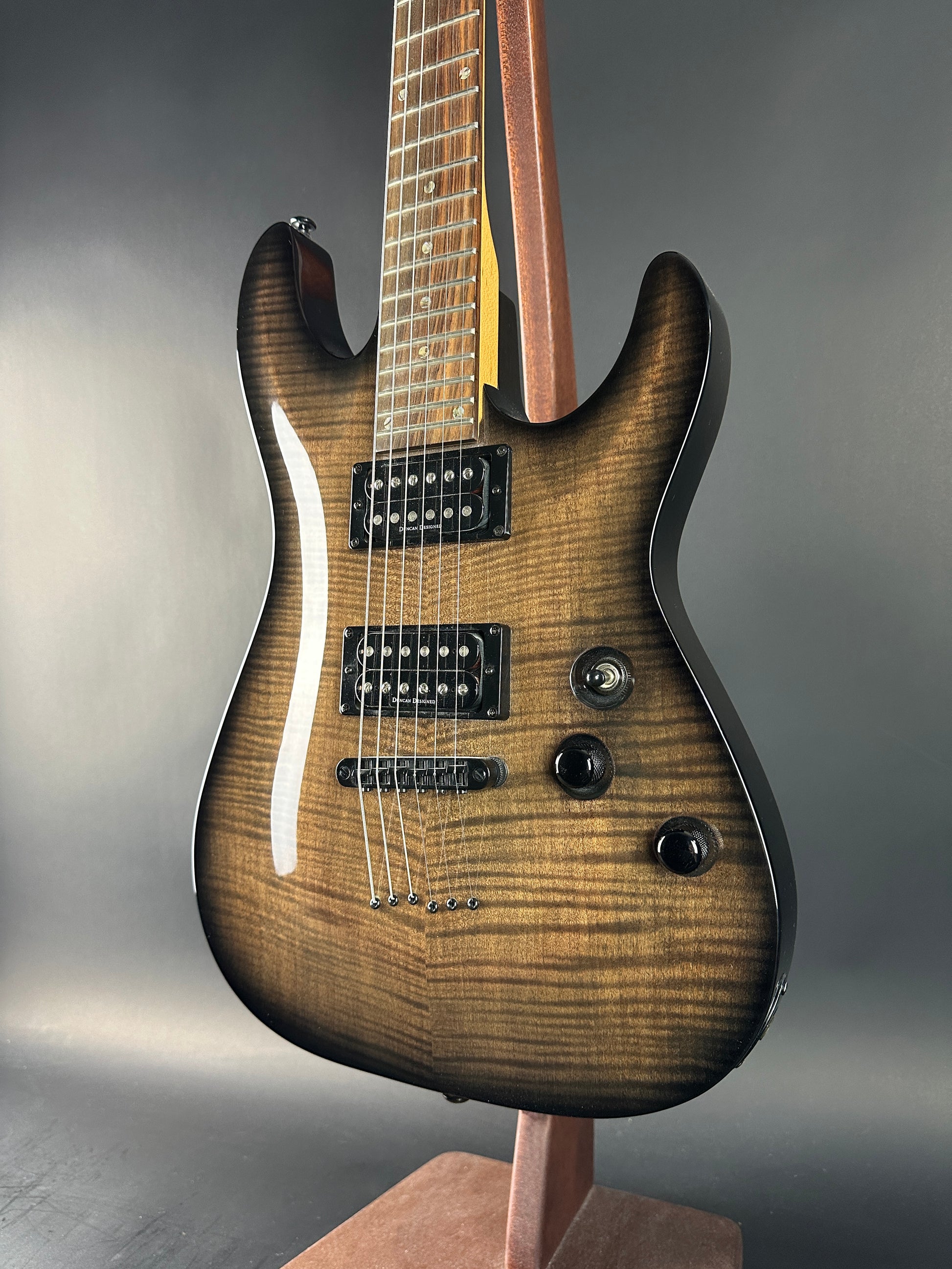 Electric guitar with a wooden finish on a gray background