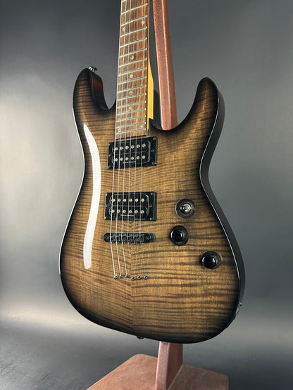 Electric guitar with a wooden finish on a gray background