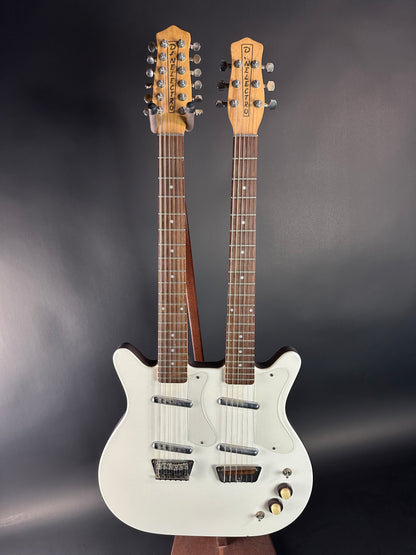 White electric guitar with two necks on a dark background