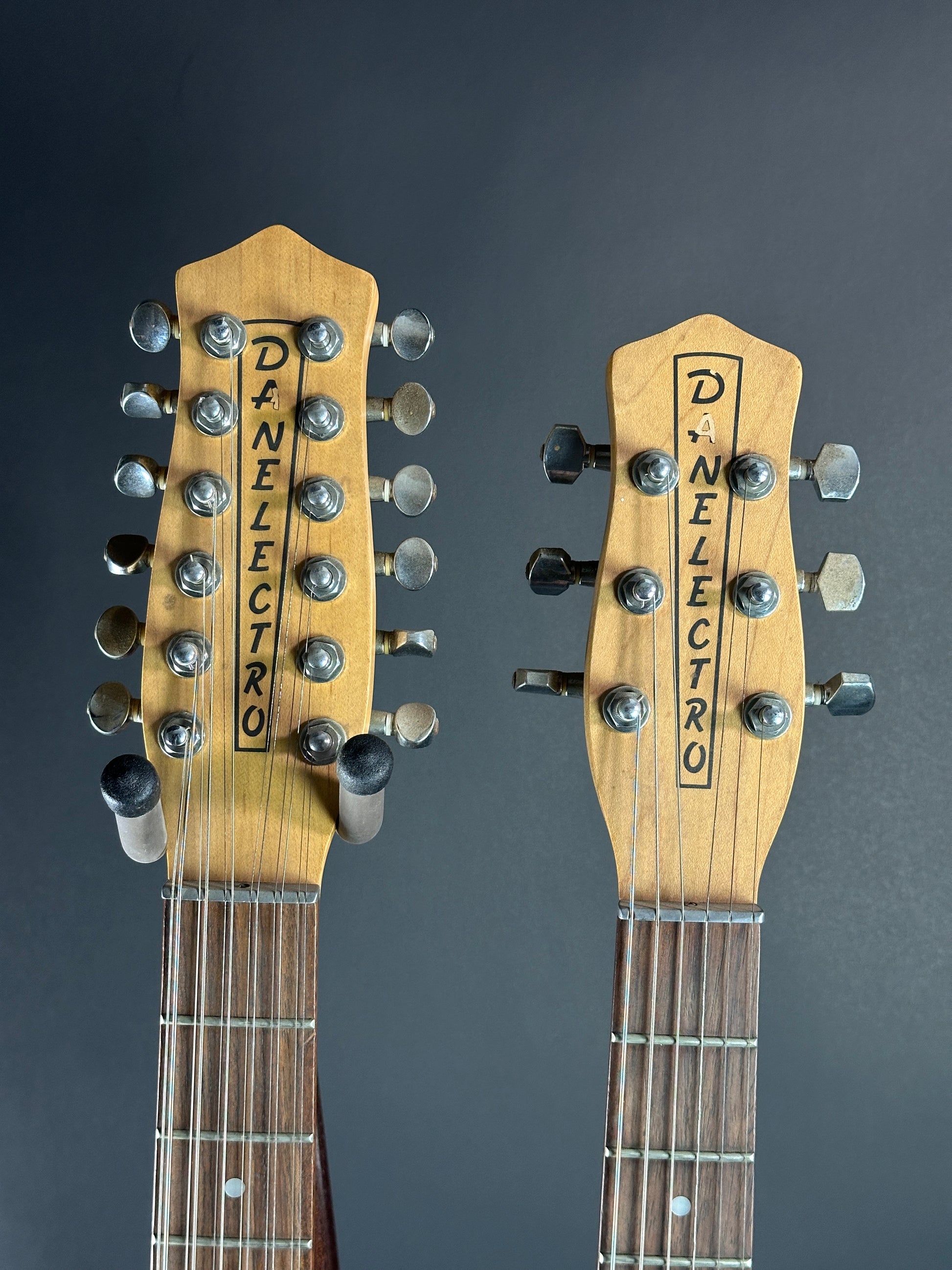 Two Danelectro guitar heads stacked on a dark background