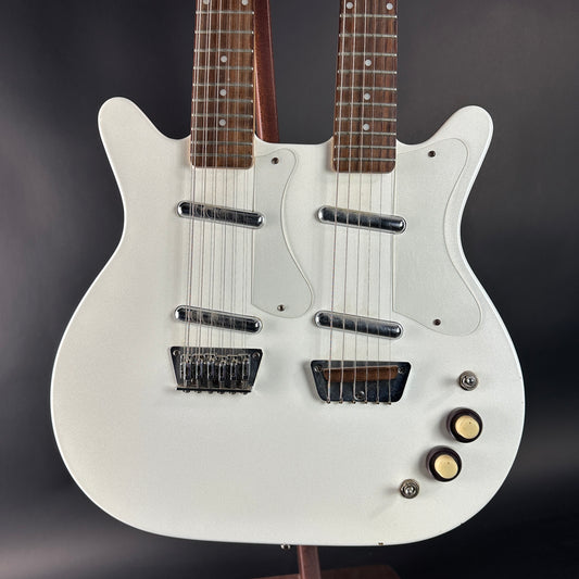 White electric guitar with dual pickups on a dark background