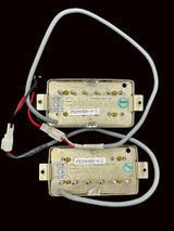 Two electronic components with wiring on a gray background