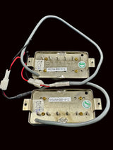 Two electronic components with wiring on a dark gray background