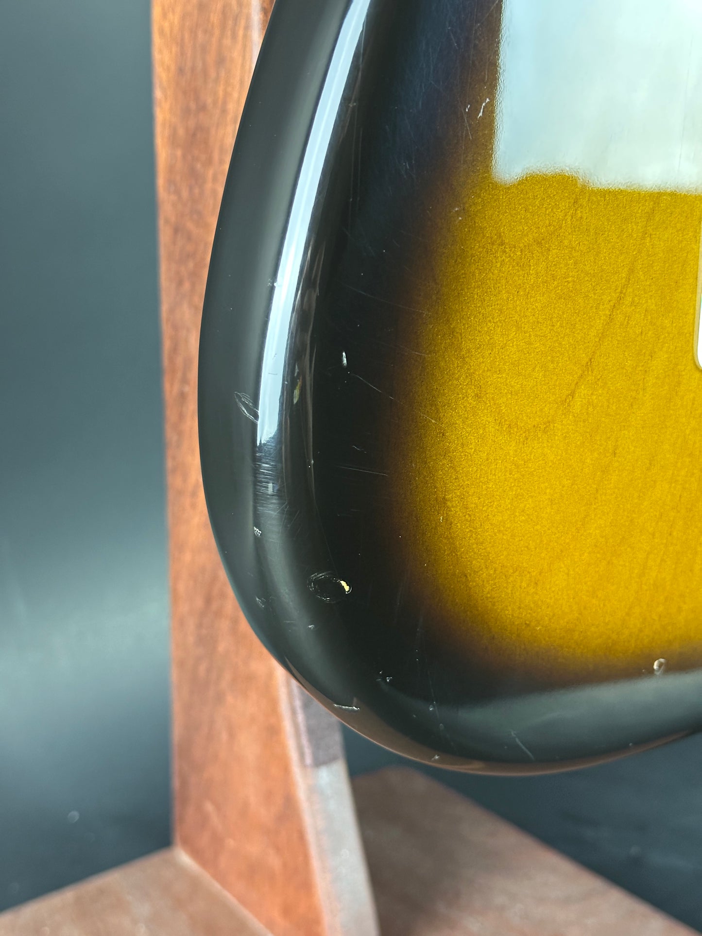 Wear on bottom edge of Used 1984 Fender Fullerton 1957 Stratocaster Reissue 2-Color Sunburst.