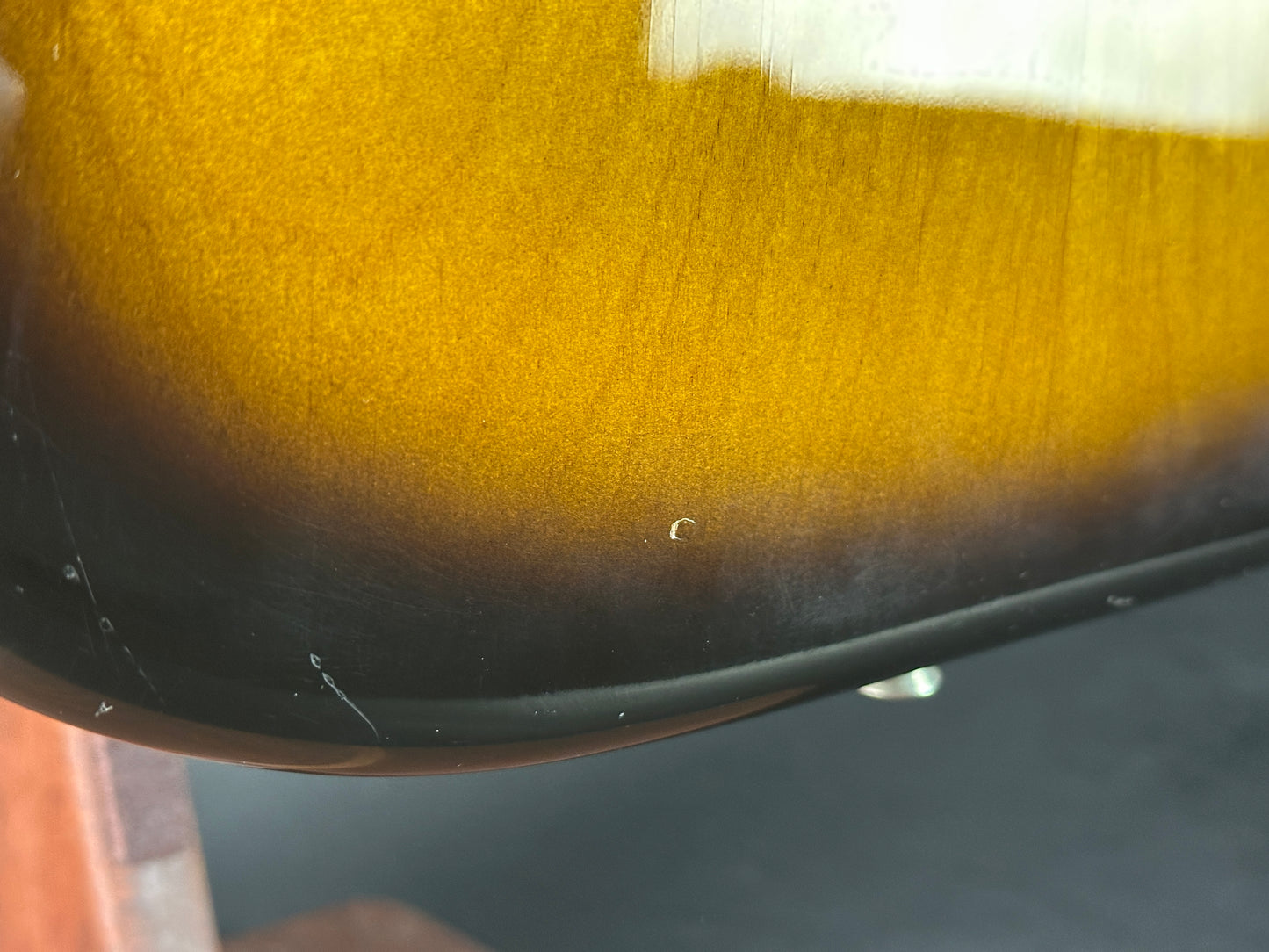 Wear on bottom edge of Used 1984 Fender Fullerton 1957 Stratocaster Reissue 2-Color Sunburst.