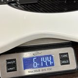 Used Klos Artemis Electric Guitar on scale displaying weight.
