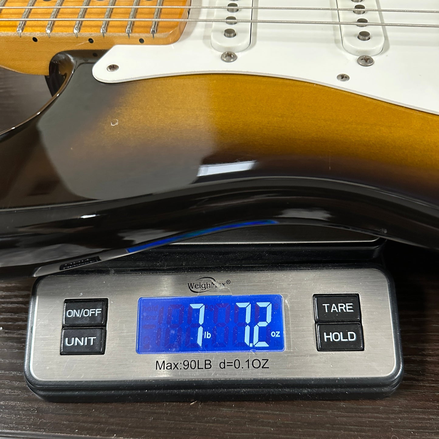 Used 1984 Fender Fullerton 1957 Stratocaster Reissue 2-Color Sunburst on scale displaying weight.