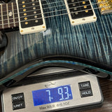 Guitar on a digital scale displaying weight