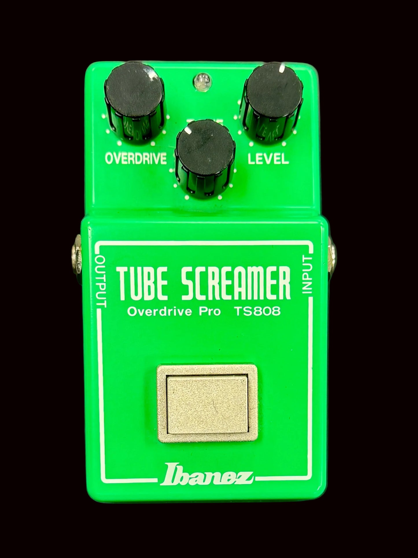 Green Ibanez Tube Screamer guitar effects pedal on a gray background