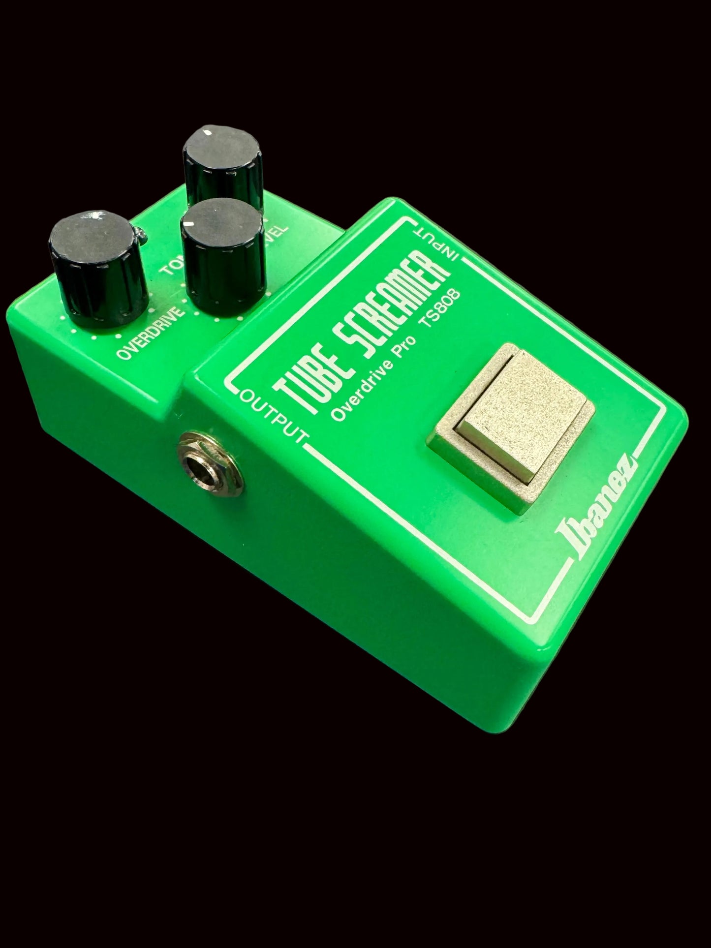 Green Ibanez Tube Screamer guitar effects pedal on a gray background