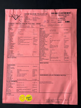 Pink paper with text and a green label on a black background