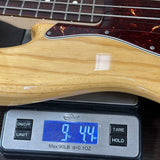 Used 2013 Fender FSR Deluxe Jazz Bass on scale displaying weight.