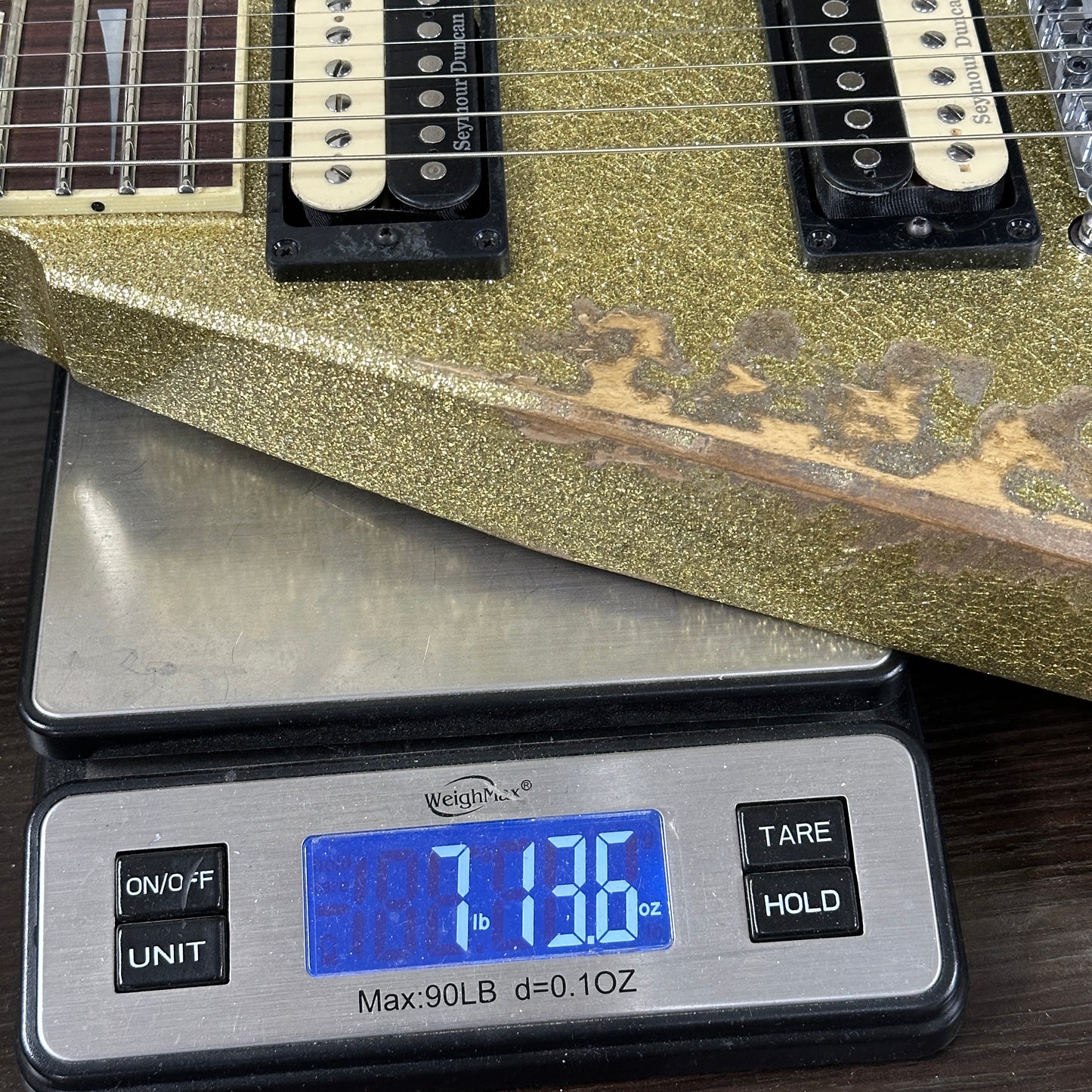 Guitar on a digital scale displaying weight