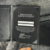Gibson Custom Certificate of Authenticity on a guitar case with a Gibson logo.