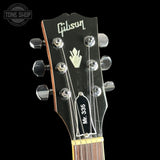 Gibson guitar headstock with brand logo on a black background