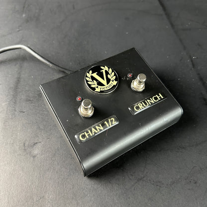 Black guitar effects pedal with 'VICTORY' branding on a gray surface