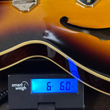 Used 2024 Epiphone Casino Sunburst on scale displaying weight.