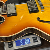 Electric guitar on a digital scale displaying weight
