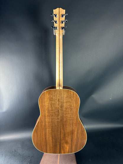 Wooden acoustic guitar on a dark gray background