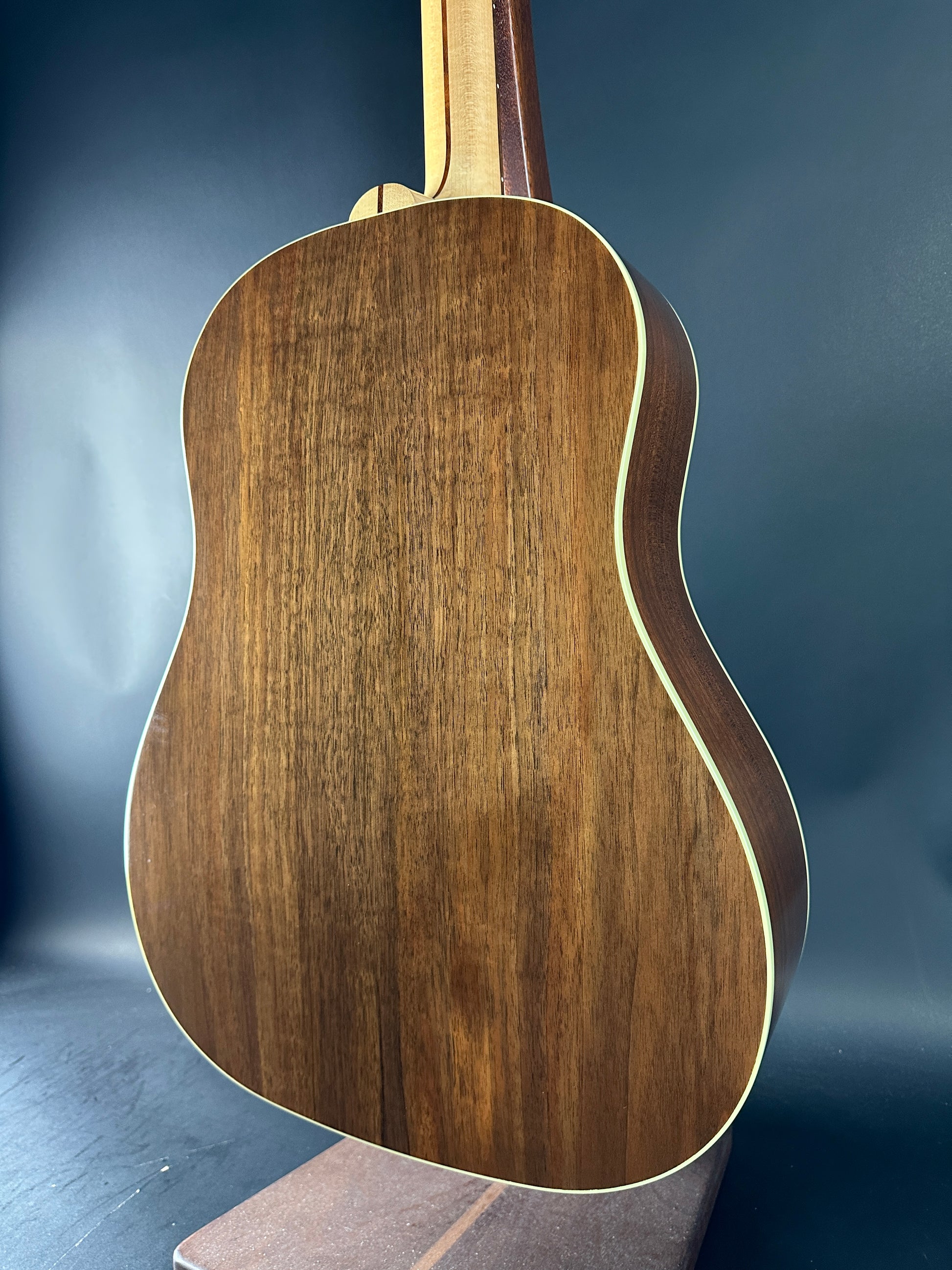 Close-up of a wooden acoustic guitar on a dark background
