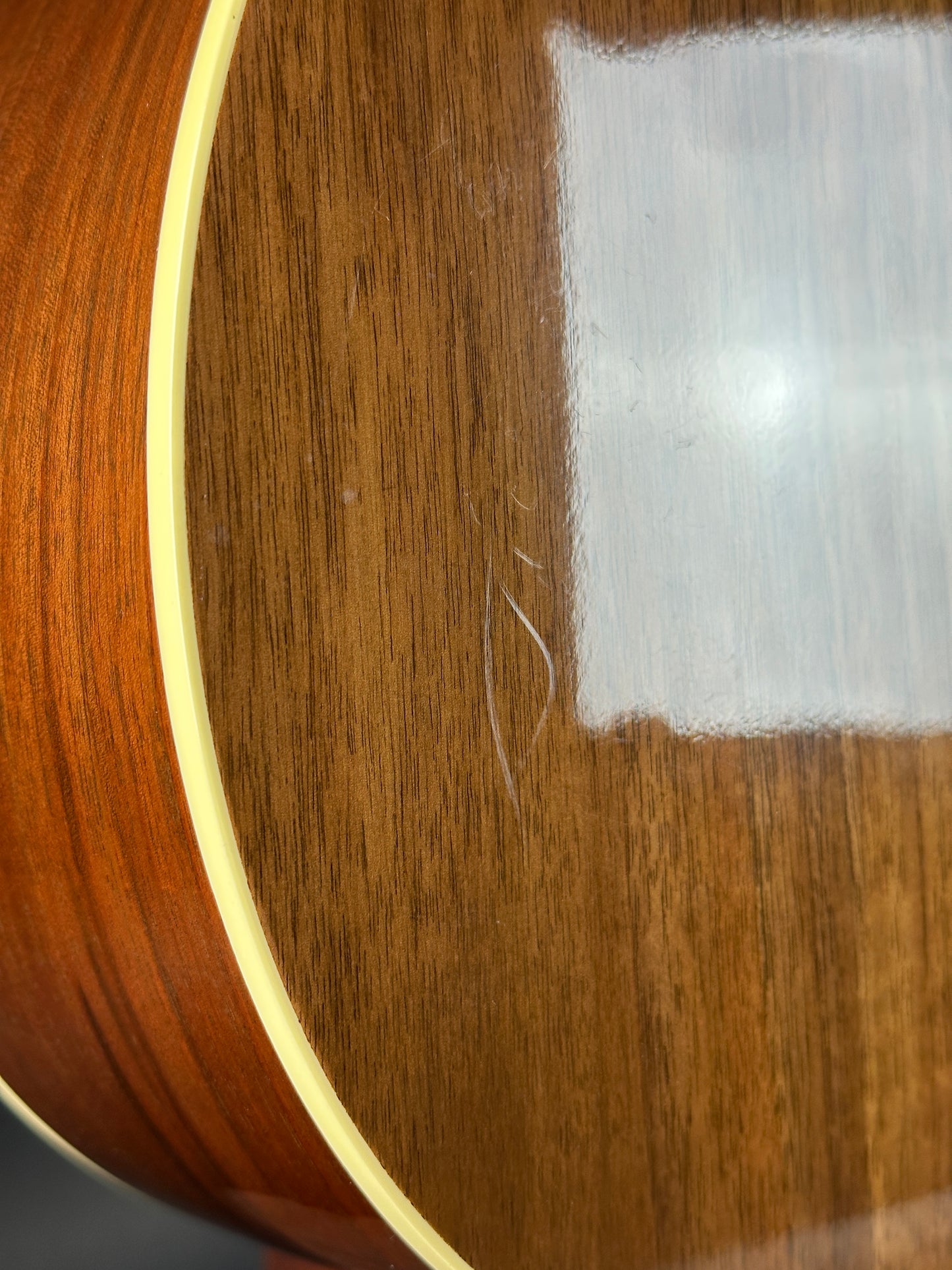 Close-up of a wooden surface with a hair strand on it