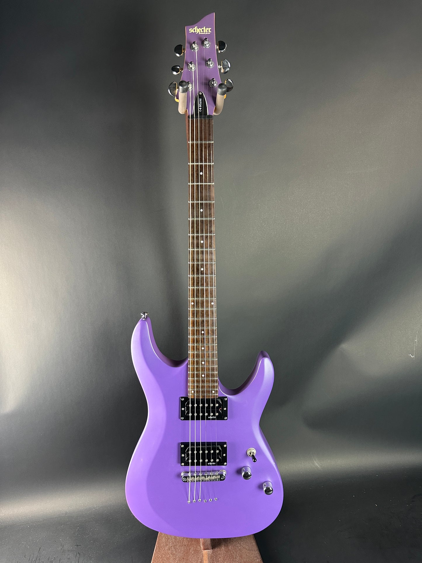 Purple electric guitar on a reflective gray surface