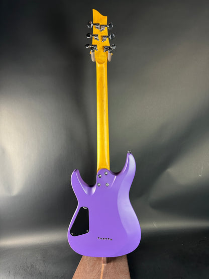 Purple electric guitar on a dark gray background