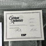 Certificate of Authenticity for an ESP guitar on a textured surface