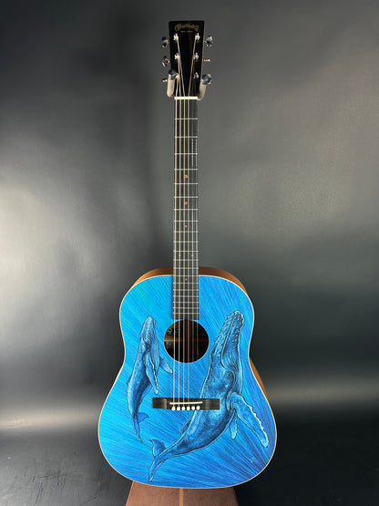 Acoustic guitar with whale design on a dark gray background