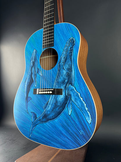 Guitar with a blue whale design on a dark background