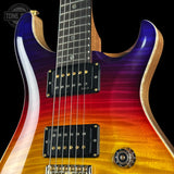 Close-up of a double-cutaway electric guitar with a vibrant flame-top finish transitioning from deep blue and purple at the top, through red and orange, to bright yellow and gold at the lower bout. The guitar features black humbucker pickups with gold screws and a dark fretboard.