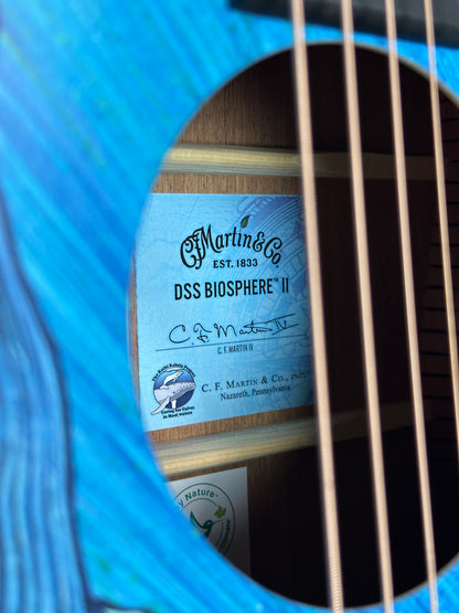 Close-up of a guitar with a label on the soundhole, showing brand details.