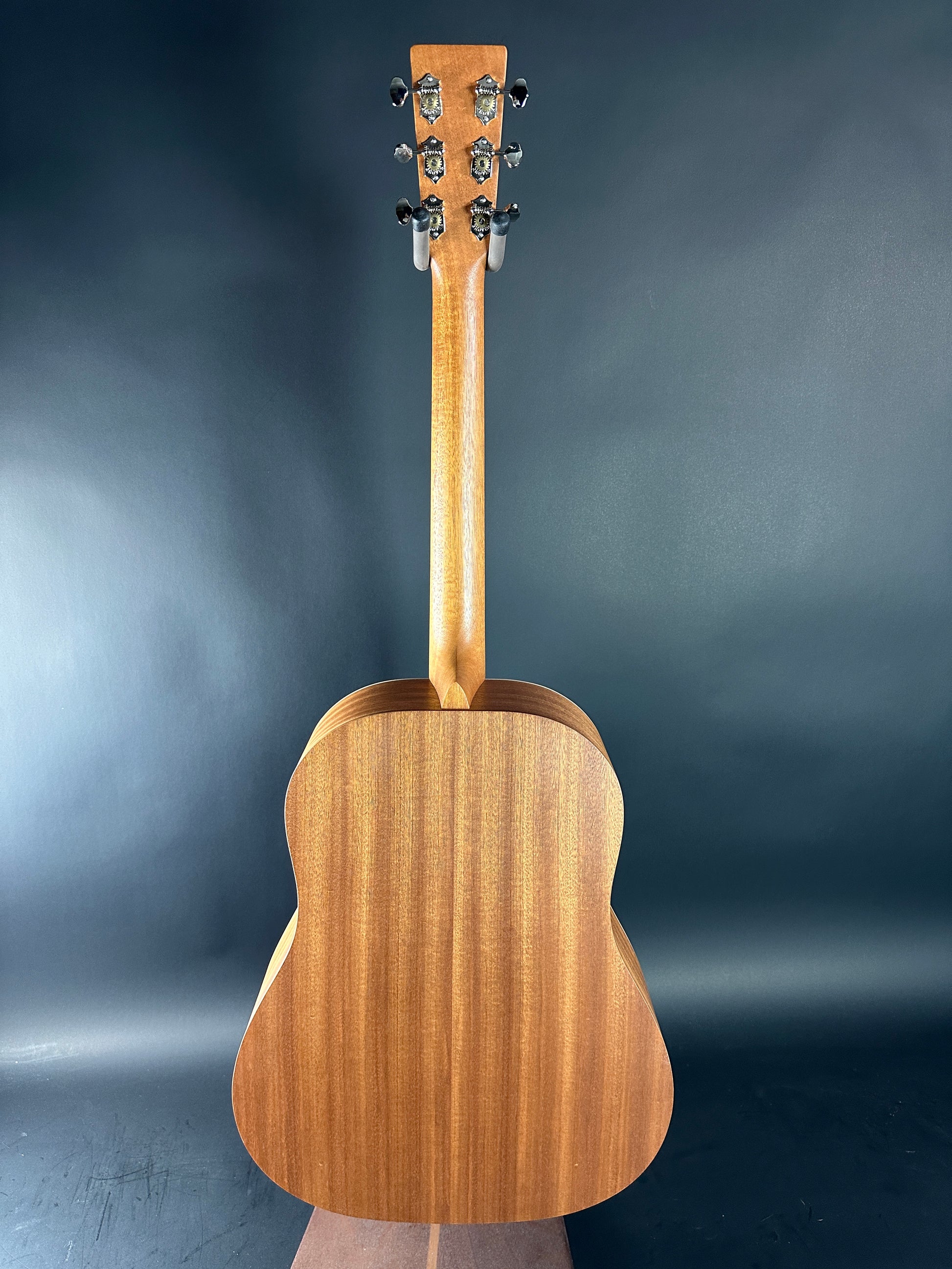 Wooden acoustic guitar on a dark background