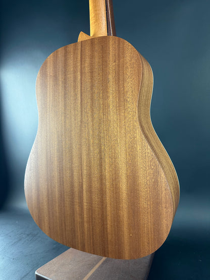 Close-up of a wooden guitar body on a dark background