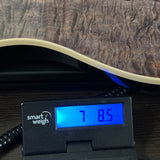 Ernie Ball Music Man 30th Anniversary Axis Translucent Black Quilt on scale displaying weight.