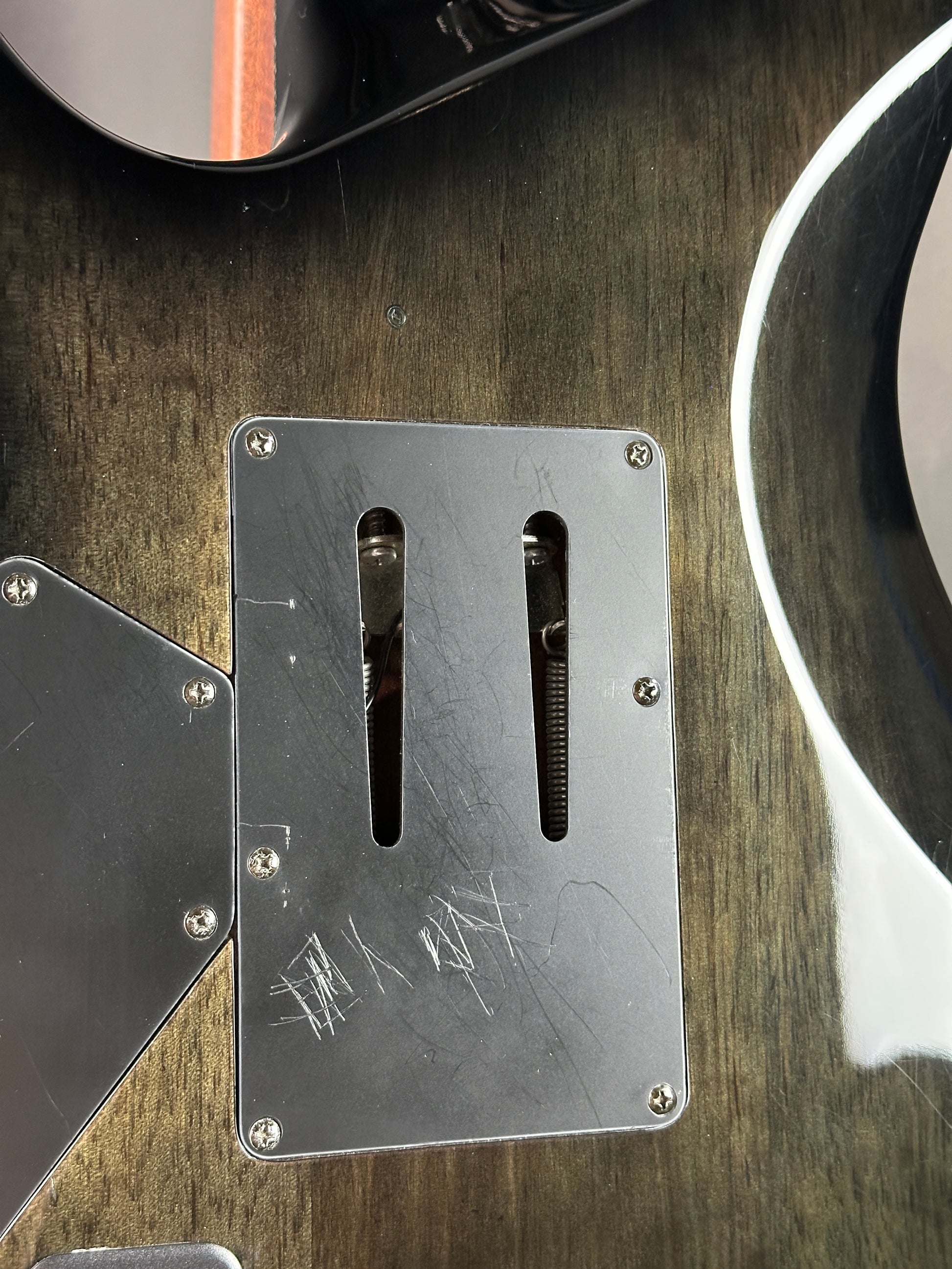 Metal plate with cutouts on a wooden surface