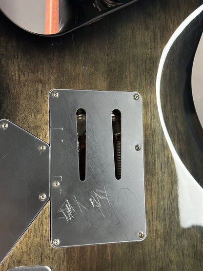 Metal plate with cutouts on a wooden surface