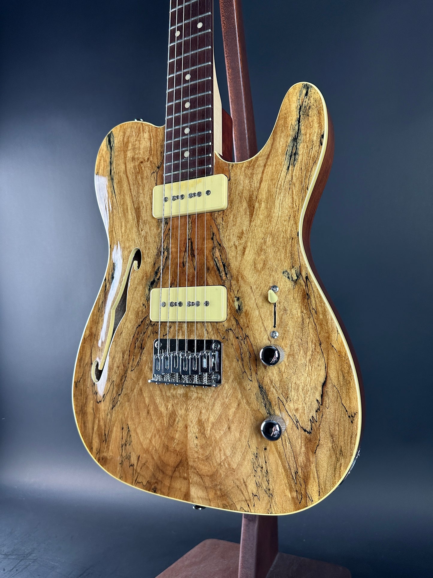 Wooden electric guitar on a dark blue background