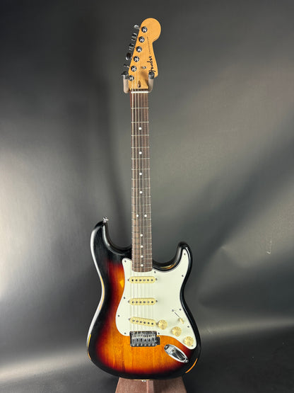 Electric guitar with a sunburst finish on a dark background