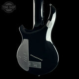 The rear view of a glossy black electric guitar body against a solid black background, featuring silver hardware and pickups.