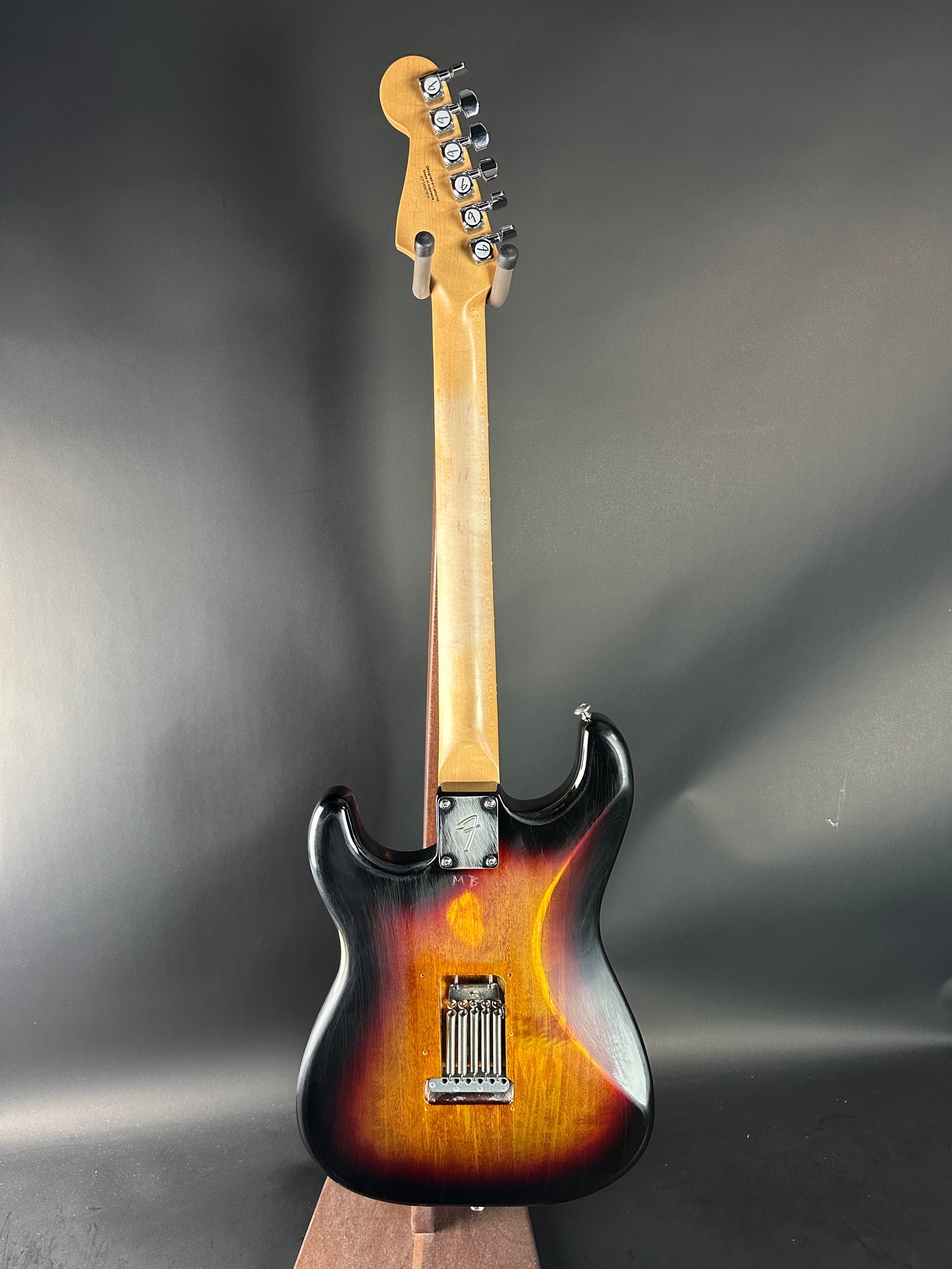 Electric guitar with sunburst finish on a gray background