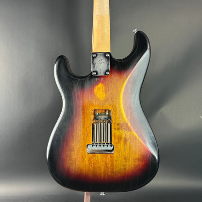 Electric guitar with a sunburst finish on a gray background